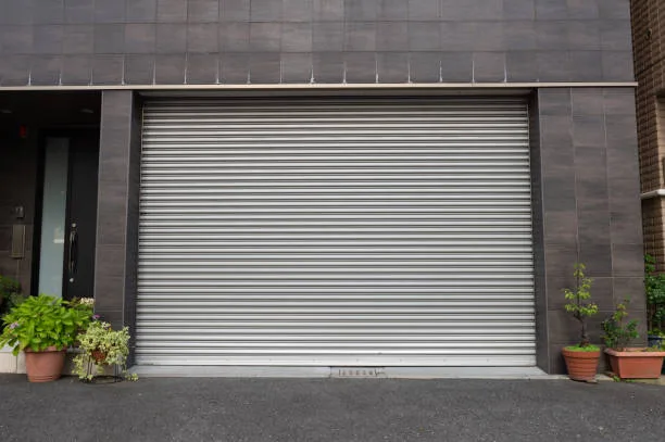 A closeup shot of automatic metal roller door used in factory, storage, garage, and industrial warehouse. The corrugated and foldable metal sheet offer space saving and provide urban and rustic feel